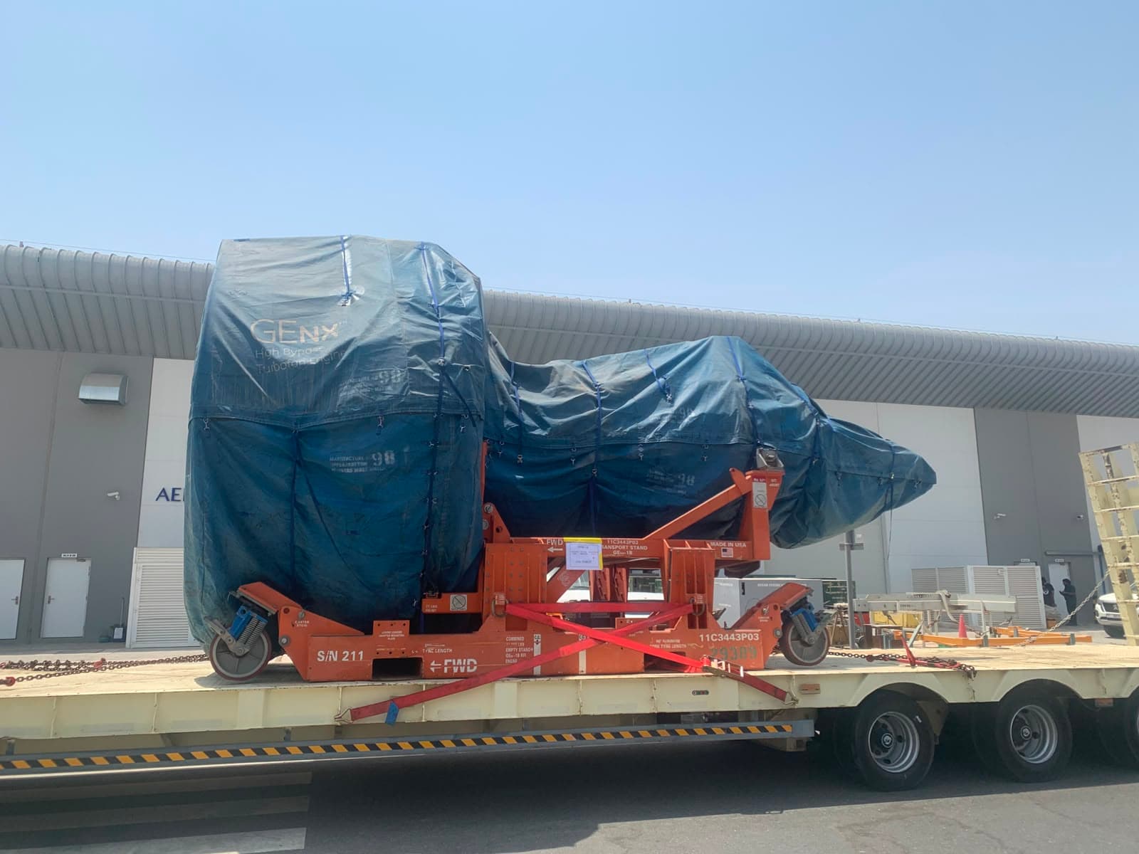 Wrapped aircraft engine secured on a specialized trailer